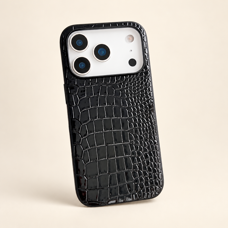 Black croc-embossed PU phone case, rear view showing the glossy texture and camera edge; iPhone version pictured