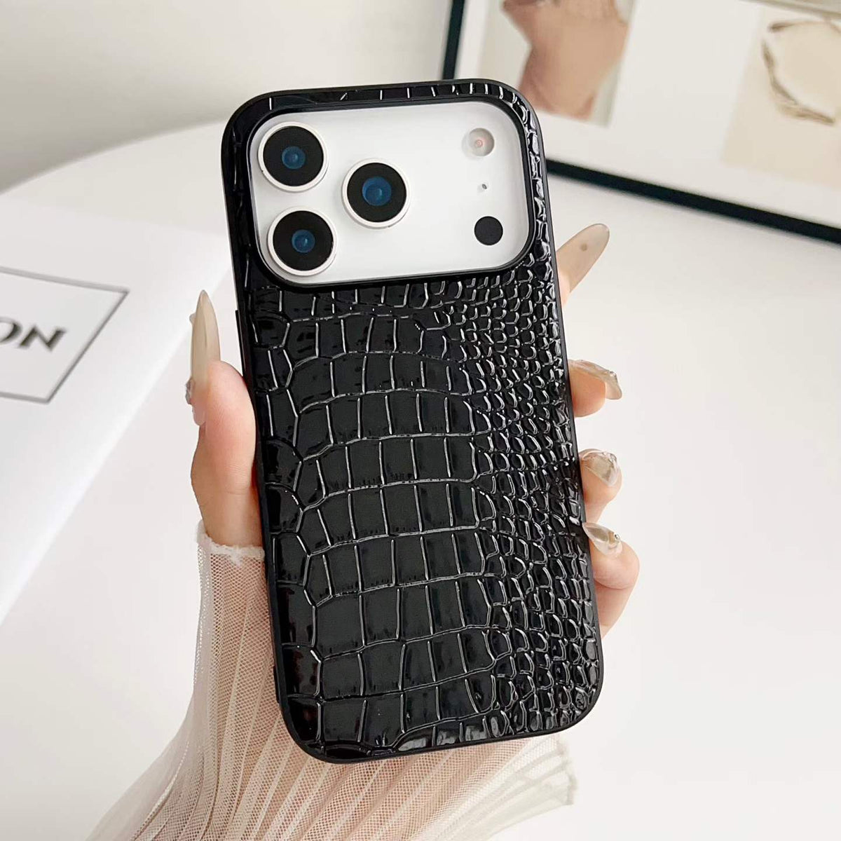 Black Croc-Embossed PU Phone Case - hand-held texture detail, iPhone shown