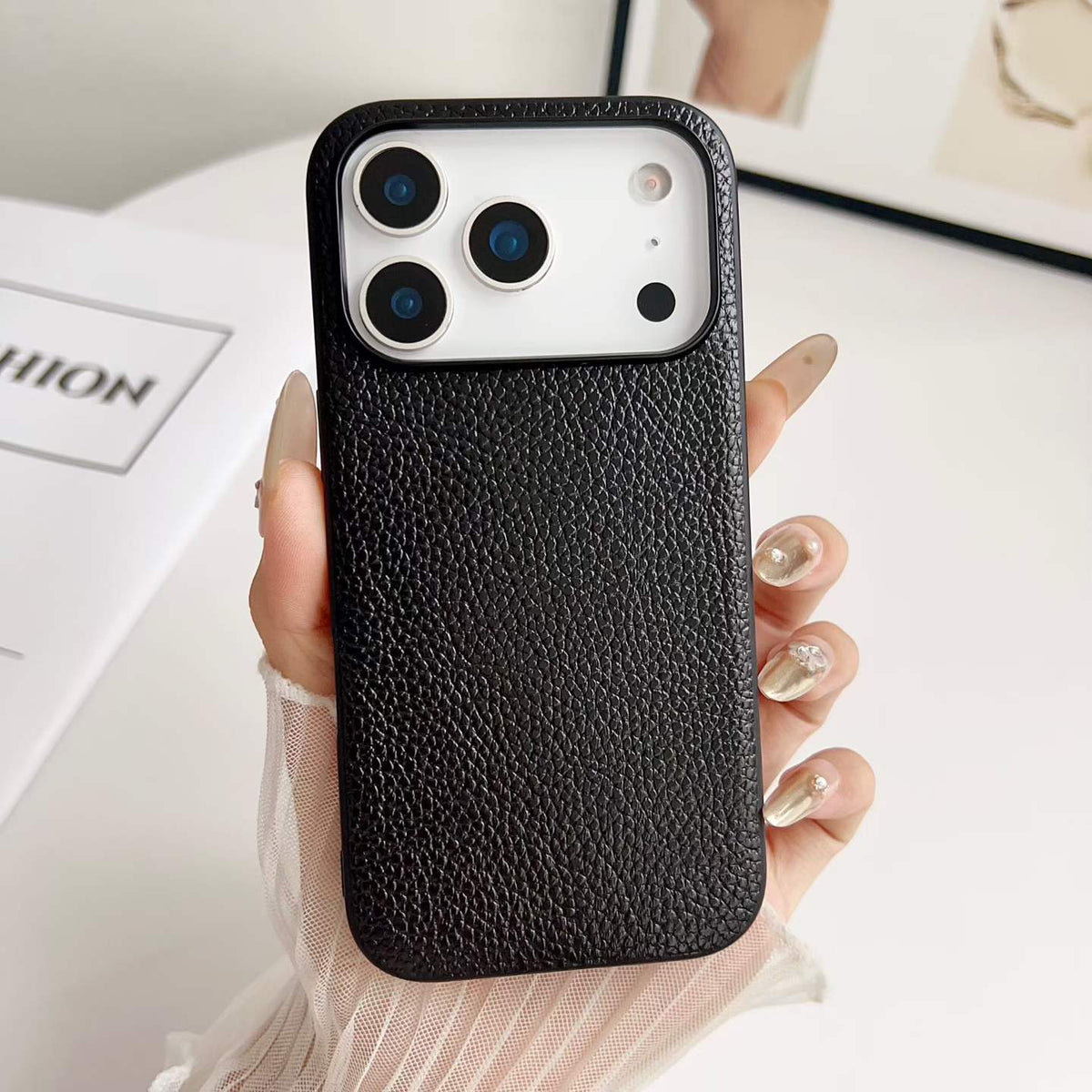 Black Pebbled PU Phone Case - hand-held texture detail, iPhone shown